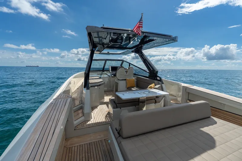 Slide: The Image of 2023 Evo Yachts R4 WA luxury yacht on open sea, featuring sleek design and spacious deck. - 43