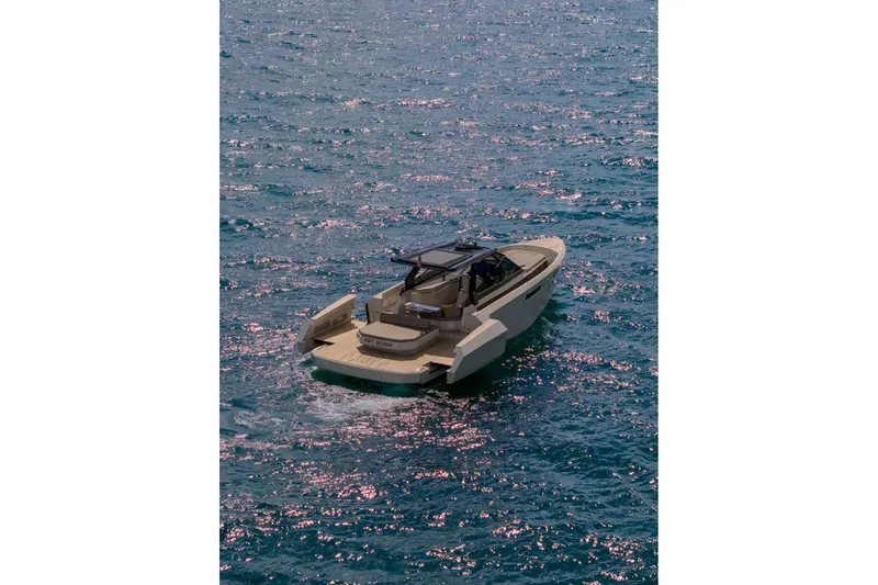 Slide: The Image of 2023 Evo Yachts R4 WA cruising on sparkling blue water. - 9