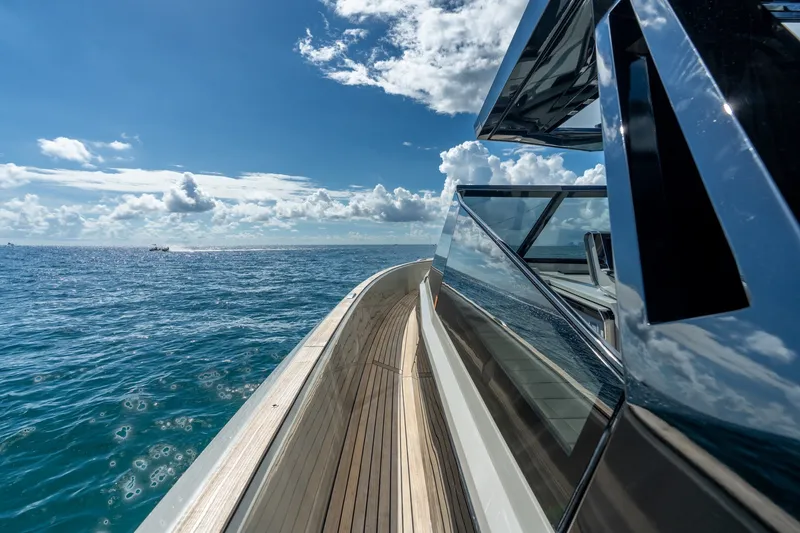 Slide: The Image of 2023 Evo Yachts R4 WA cruising on open sea under clear blue sky. - 39