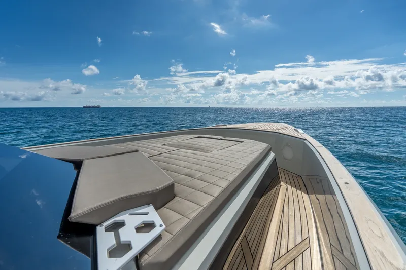 Slide: The Image of 2023 Evo Yachts R4 WA luxury yacht deck with ocean view under blue sky. - 36