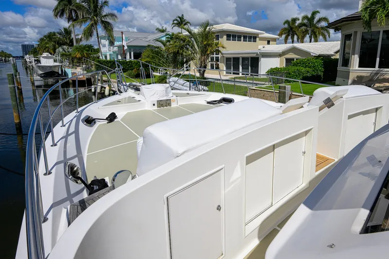 Slide: The Image of 2008 Grand Banks 72 Aleutian RP yacht docked near waterfront homes, surrounded by palm trees. - 34