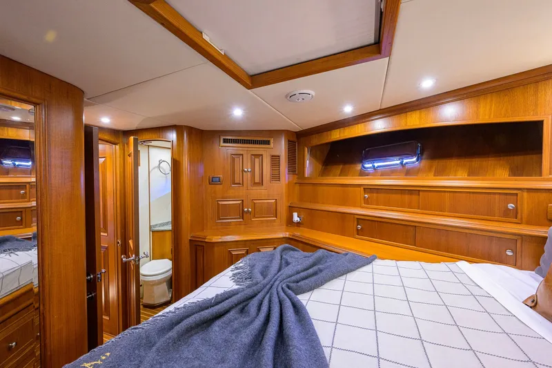 Slide: The Image of Luxurious wooden interior of 2008 Grand Banks 72 Aleutian RP yacht cabin with bed and ensuite bathroom. - 21