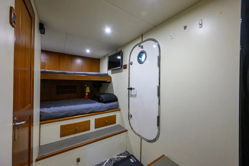 Slide: The Image of Cozy cabin interior of 2008 Grand Banks 72 Aleutian RP with bunk beds and porthole door. - 42