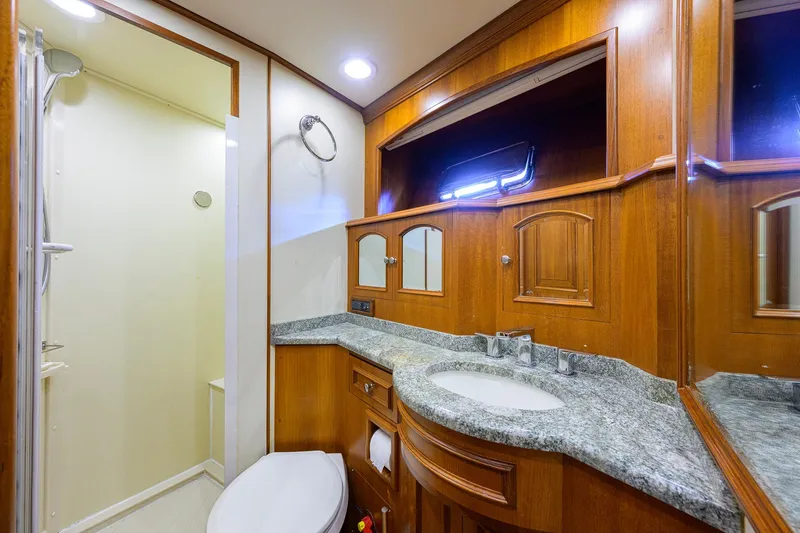 Slide: The Image of Luxurious bathroom in 2008 Grand Banks 72 Aleutian RP yacht with wood cabinetry and granite countertop. - 22