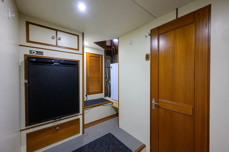 Slide: The Image of Interior of 2008 Grand Banks 72 Aleutian RP yacht, featuring wooden cabinetry and modern amenities. - 45