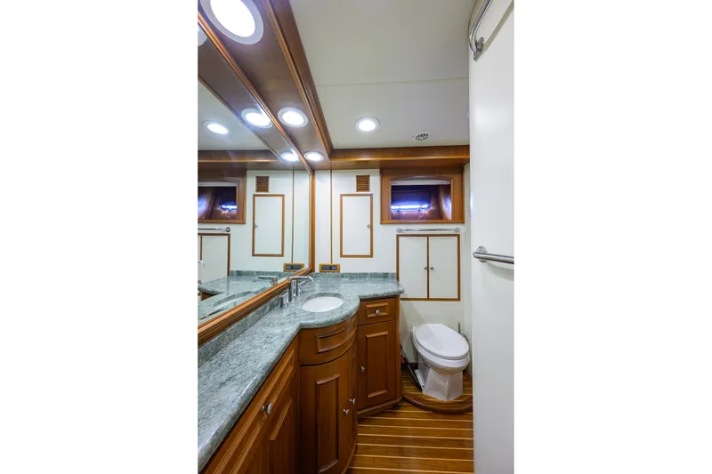 Slide: The Image of Luxurious bathroom in 2008 Grand Banks 72 Aleutian RP yacht with wood accents and granite countertop. - 18