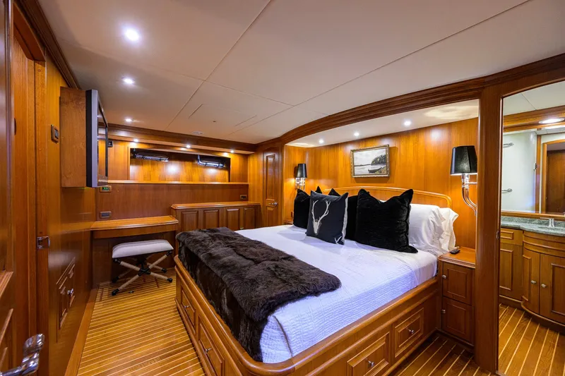 Slide: The Image of Luxurious 2008 Grand Banks 72 Aleutian RP yacht bedroom with elegant wood paneling and plush bedding. - 15