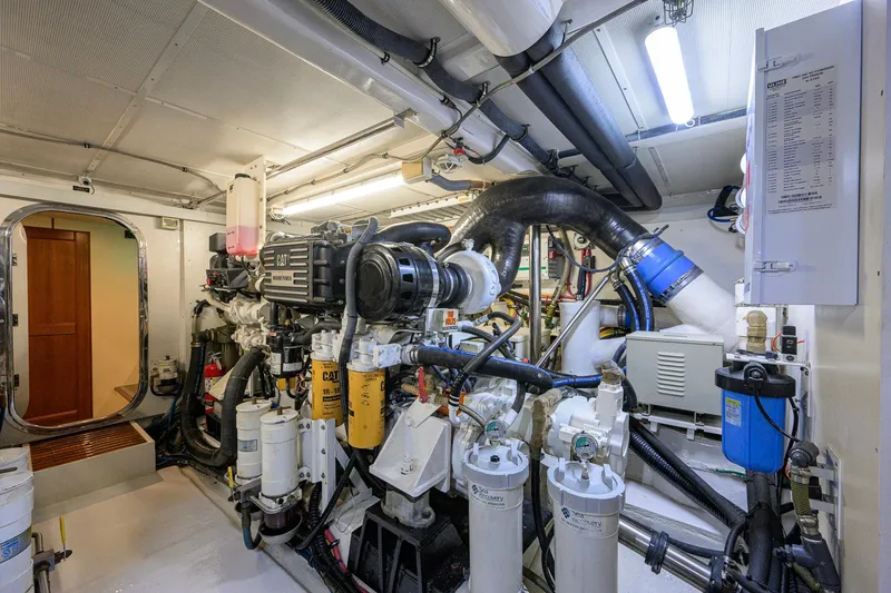 Slide: The Image of Engine room of 2008 Grand Banks 72 Aleutian RP yacht, featuring CAT machinery and complex piping. - 47