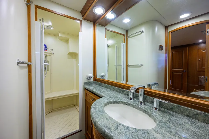 Slide: The Image of Luxurious bathroom in 2008 Grand Banks 72 Aleutian RP yacht with granite countertop and shower. - 19