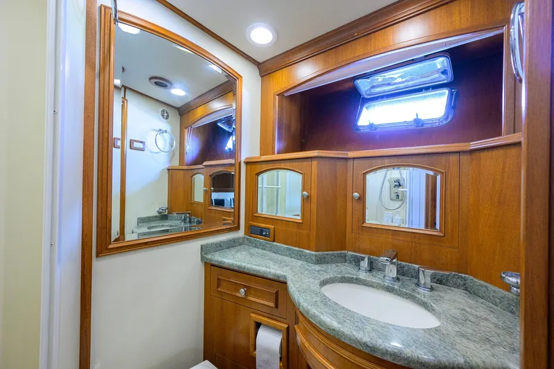 Slide: The Image of Luxurious bathroom in 2008 Grand Banks 72 Aleutian RP yacht with wood cabinetry and granite countertop. - 27