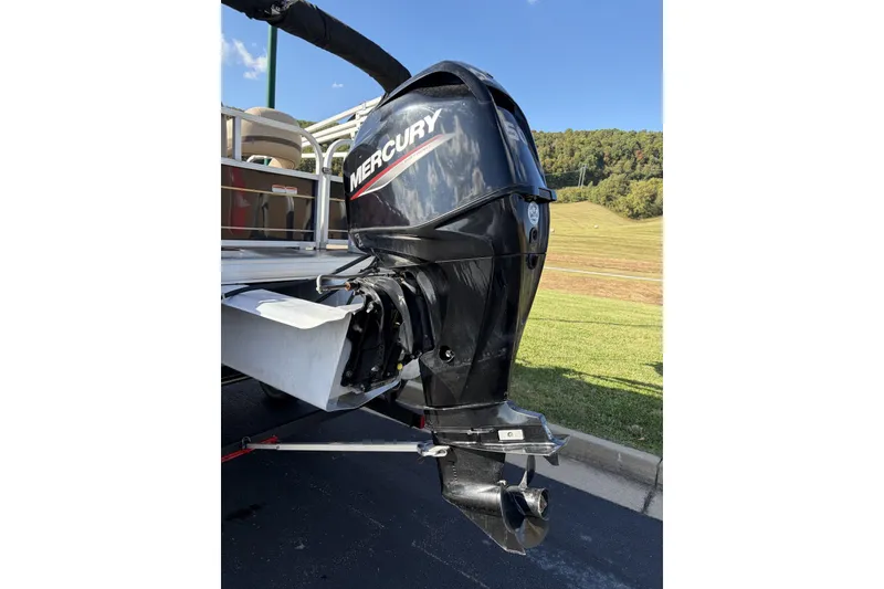 Slide: The Image of 2021 Sun Tracker Bass Buggy 16 DLX with Mercury outboard motor, parked on pavement. - 14