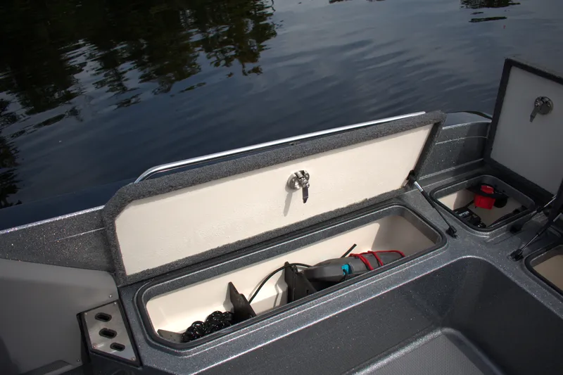 Slide: The Image of 2023 Ranger 622FS Pro boat storage compartments with gear, on calm water. - 20