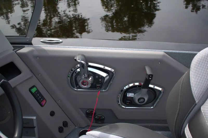 Slide: The Image of Interior controls of a 2023 Ranger 622FS Pro boat, featuring throttle and steering mechanisms. - 18