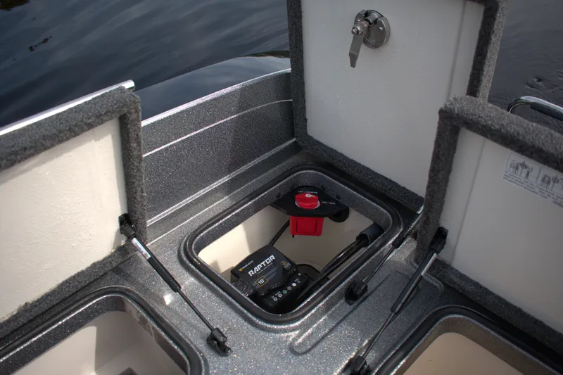 Slide: The Image of 2023 Ranger 622FS Pro boat storage compartments with battery and switch. - 19
