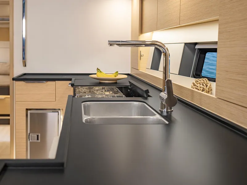 Slide: The Image of Modern kitchen area in the 2024 Hanse 510 yacht with sleek countertops and stainless steel sink. - 11