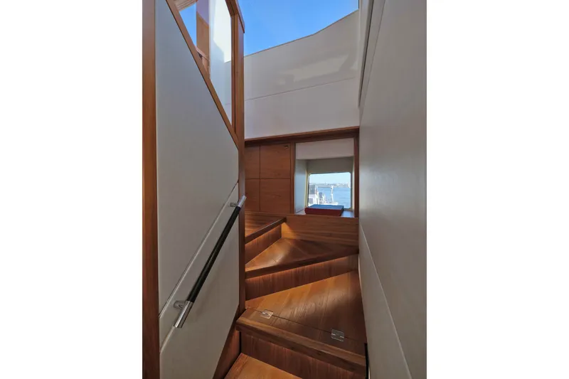 Slide: The Image of Interior staircase of 2018 Sunseeker 76 Yacht with wooden finish and ocean view. - 73