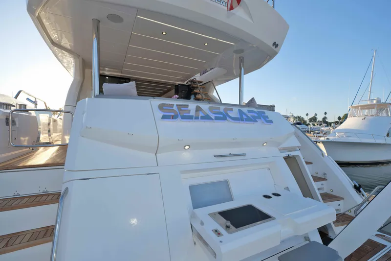Slide: The Image of Sunseeker 76 Yacht 2018, rear view with "Seascape" signage, docked at marina. - 80
