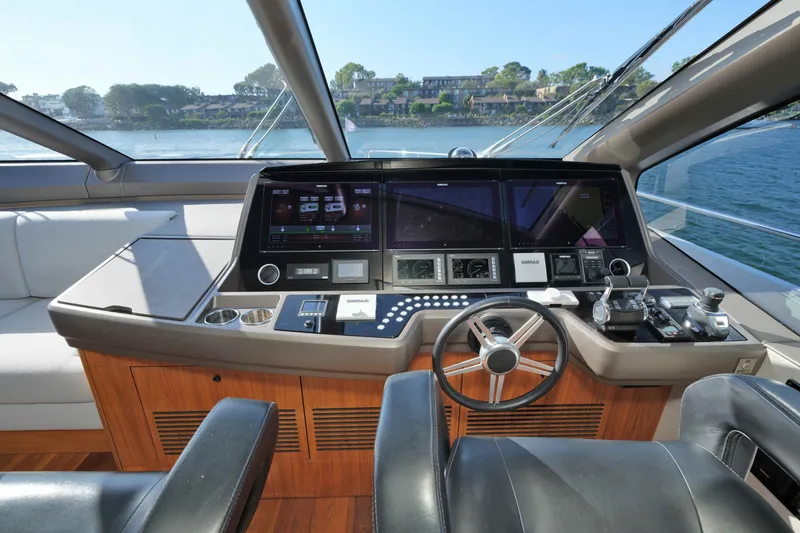 Slide: The Image of Luxurious helm of 2018 Sunseeker 76 Yacht with advanced navigation controls and panoramic view. - 30