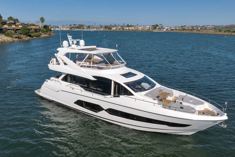 Slide: The Image of Luxurious 2018 Sunseeker 76 Yacht cruising on a scenic waterway. - 2