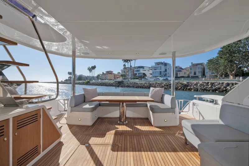 Slide: The Image of Luxurious 2018 Sunseeker 76 Yacht deck with elegant seating and scenic waterfront view. - 18