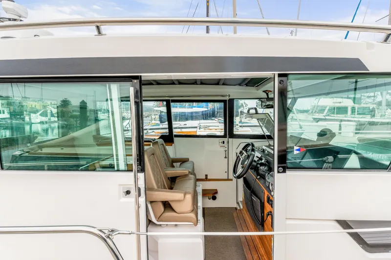 Slide: The Image of 2019 Axopar 37 Cabin interior view with leather seats and steering wheel. - 18