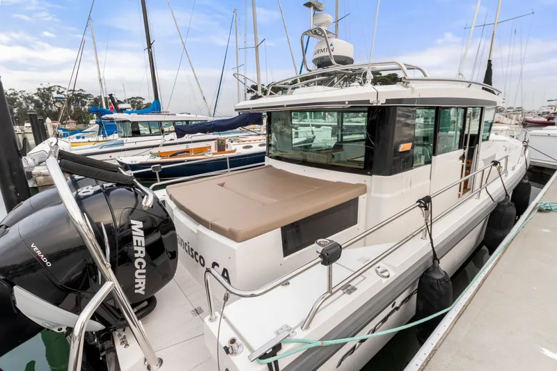 Slide: The Image of 2019 Axopar 37 Cabin boat docked, featuring Mercury Verado engines. - 17