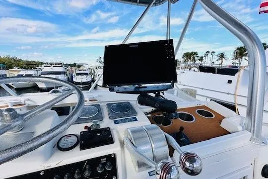 Slide: The Image of 2001 Luhrs 40 Convertible boat helm with steering wheel and navigation equipment. - 11