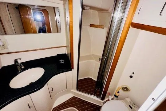 Slide: The Image of Luxurious bathroom in 2001 Luhrs 40 Convertible yacht with modern fixtures and wood accents. - 8