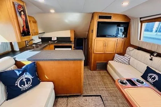 Slide: The Image of Interior of 2001 Luhrs 40 Convertible yacht with cozy seating and modern kitchen. - 2