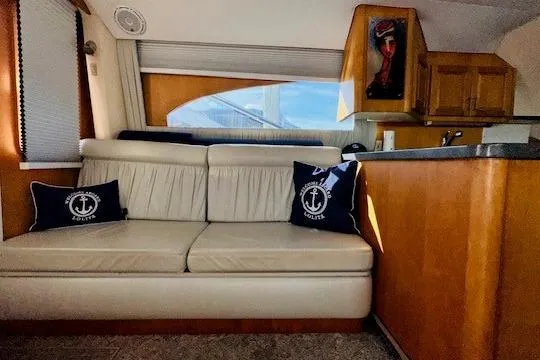 Slide: The Image of Interior of 2001 Luhrs 40 Convertible yacht with cream sofa and nautical-themed pillows. - 4