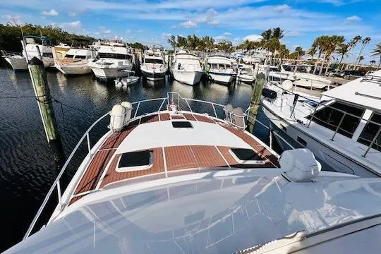 Slide: The Image of 2001 Luhrs 40 Convertible yacht docked in a marina, surrounded by other boats. - 14