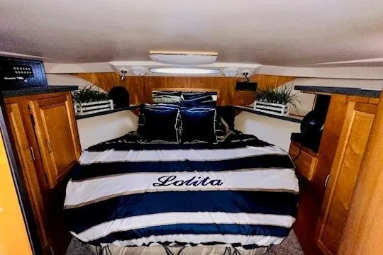 Slide: The Image of Luxurious cabin interior of 2001 Luhrs 40 Convertible yacht with striped bedding. - 7