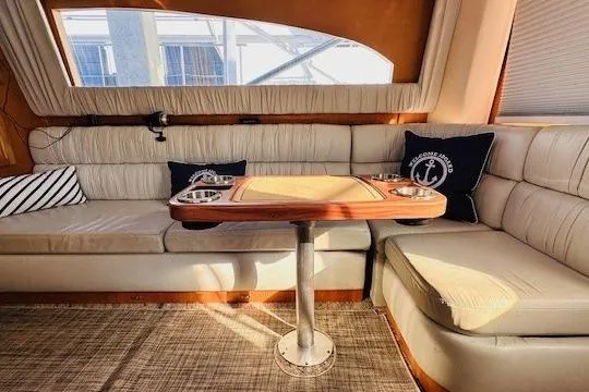 Slide: The Image of Interior of 2001 Luhrs 40 Convertible yacht with cozy seating and nautical decor. - 3