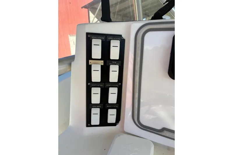 Slide: The Image of Control panel of a 2000 Cape Horn 27XS boat with labeled switches. - 42