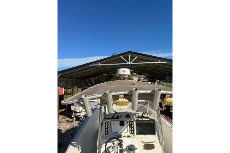 Slide: The Image of Cape Horn 27XS boat from 2000 under a metal shelter, clear blue sky above. - 51