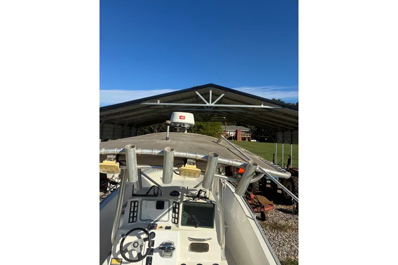 Slide: The Image of Cape Horn 27XS boat from 2000 under a metal shelter, featuring a steering console. - 52