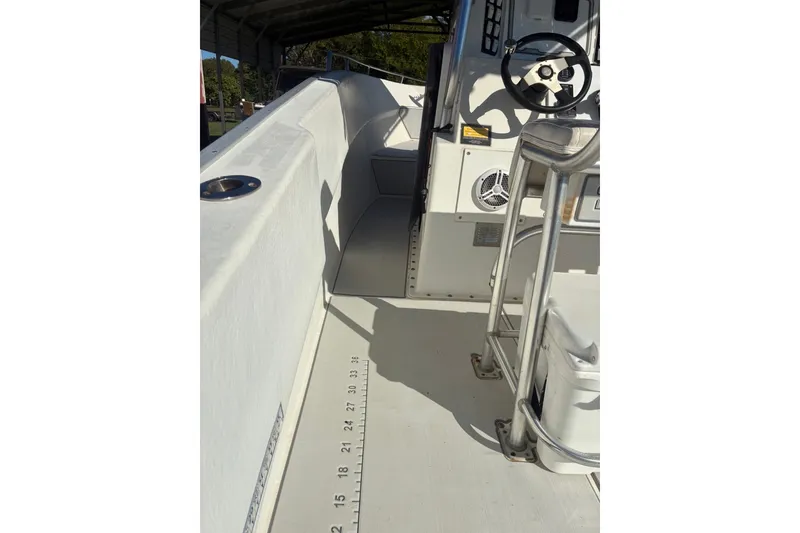 Slide: The Image of Interior view of a 2000 Cape Horn 27XS boat, featuring steering wheel and seating area. - 45