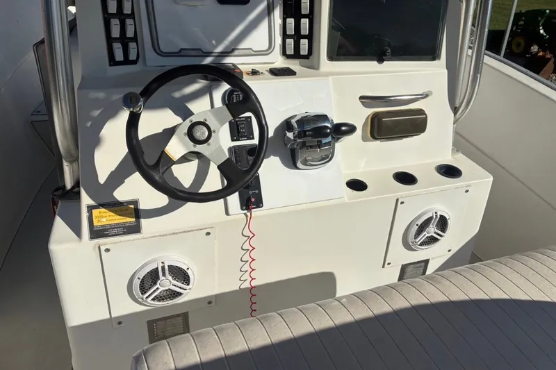 Slide: The Image of Console of a 2000 Cape Horn 27XS boat with steering wheel and controls. - 37