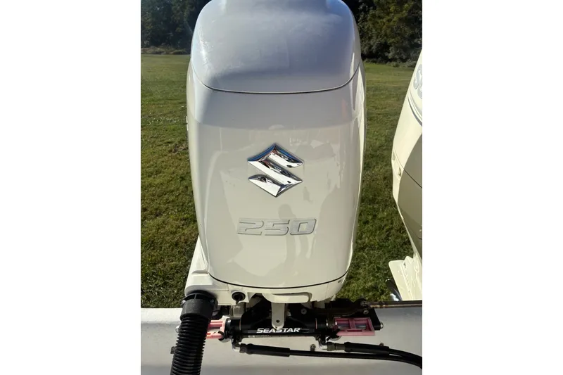 Slide: The Image of Suzuki 250 outboard motor on a 2000 Cape Horn 27XS boat, displayed outdoors. - 22
