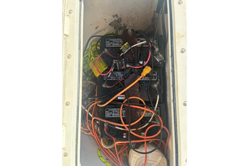 Slide: The Image of Battery compartment of a 2000 Cape Horn 27XS boat with visible wiring. - 55