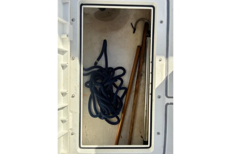 Slide: The Image of Storage compartment of a 2000 Cape Horn 27XS boat with rope and boat hook. - 57