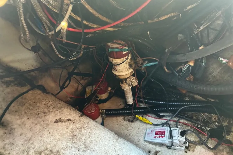 Slide: The Image of Boat wiring and plumbing in a 2000 Cape Horn 27XS, showing cables and connections. - 62