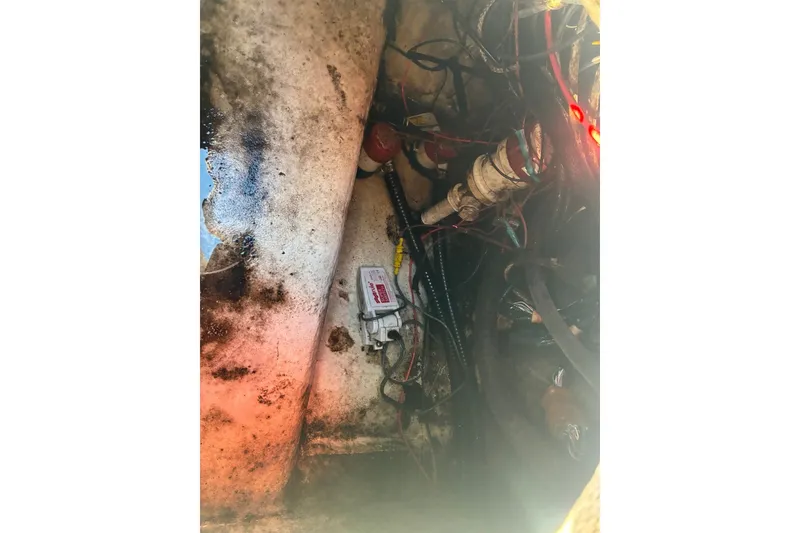 Slide: The Image of Engine compartment of a 2000 Cape Horn 27XS boat, showing wiring and components. - 60