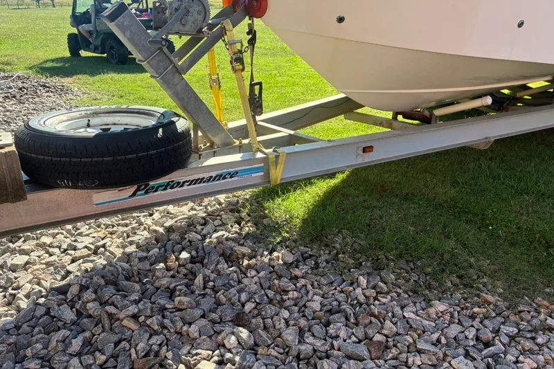 Slide: The Image of Trailer with Cape Horn 27XS boat, 2000 model, on gravel and grass surface. - 7