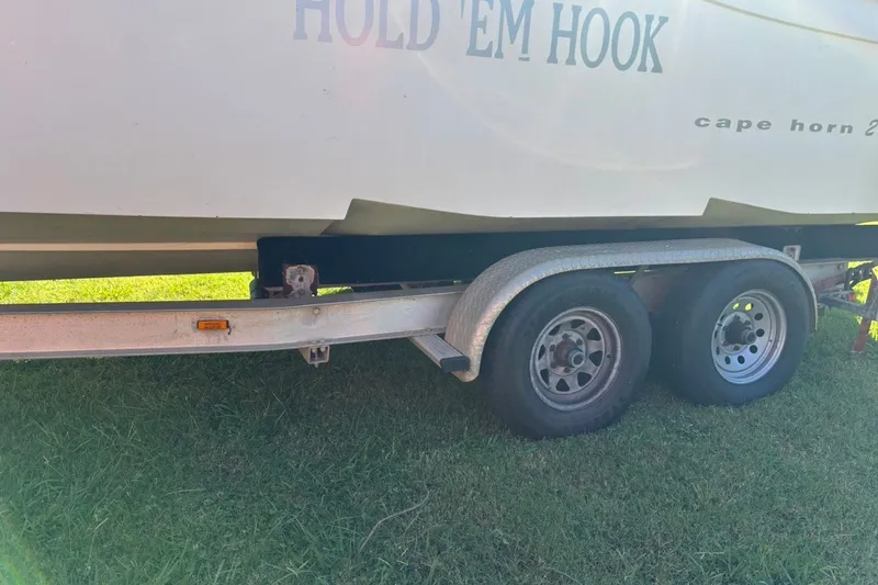 Slide: The Image of Trailer with Cape Horn 27XS boat, year 2000, on grassy area. - 8