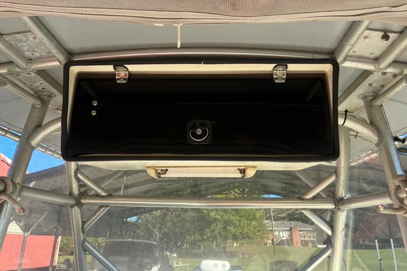 Slide: The Image of Storage compartment on a 2000 Cape Horn 27XS boat, featuring metal framework and latches. - 38