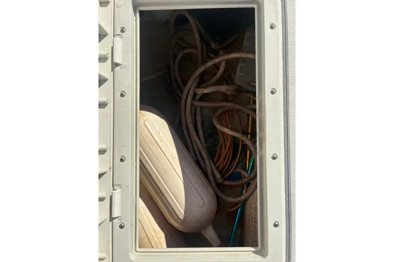 Slide: The Image of Storage compartment of a 2000 Cape Horn 27XS boat with ropes and fenders. - 56