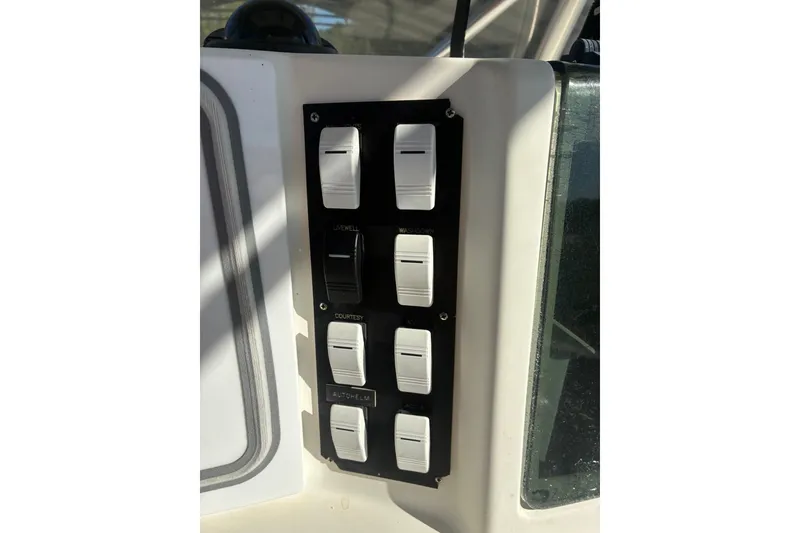 Slide: The Image of Control panel with switches on a 2000 Cape Horn 27XS boat. - 44