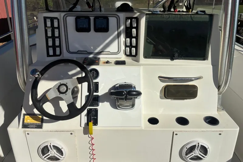 Slide: The Image of Control panel of a 2000 Cape Horn 27XS boat with steering wheel and gauges. - 36