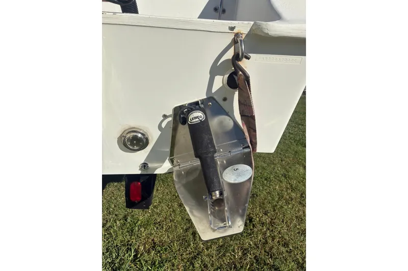 Slide: The Image of Cape Horn 27XS 2000 boat detail with Lenco trim tab on grassy background. - 54